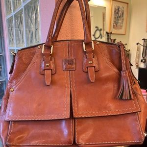 Dooney & Bourke large leather camel color tote or purse .  Lots of pockets.
